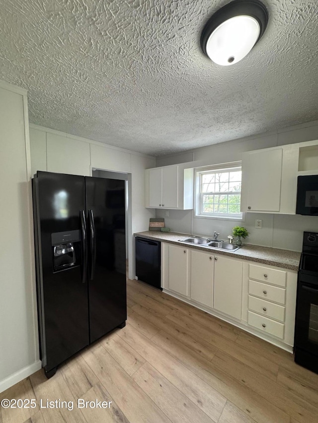 490 Blackjack Rd, Radcliff, KY 40160 - kitchen featuring black appliances, a sink, light wood-style flooring, a textured ceiling, and white cabinets