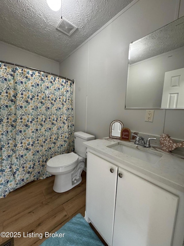 490 Blackjack Rd, Radcliff, KY 40160 - bathroom with wood finished floors, a textured ceiling, toilet, vanity, and a shower with shower curtain
