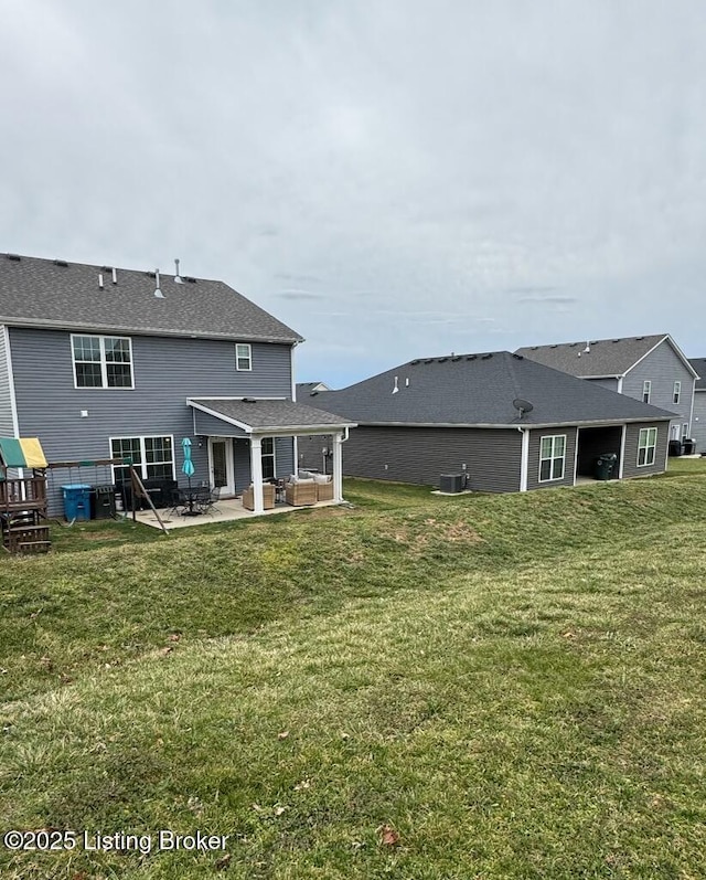 117 Richwood Cir, Georgetown, KY 40324 - rear view of house with a patio area, a lawn, and central AC