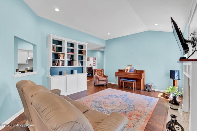 living room with recessed lighting, baseboards, vaulted ceiling, and wood finished floors