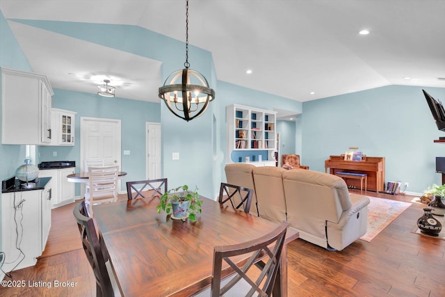 dining space with recessed lighting, an inviting chandelier, wood finished floors, and lofted ceiling