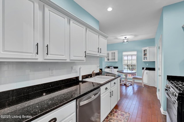 kitchen featuring tasteful backsplash, a sink, white cabinets, and stainless steel appliances