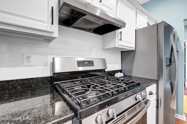 kitchen featuring gas range, under cabinet range hood, decorative backsplash, and white cabinets