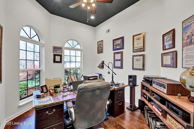 office area with dark wood-type flooring, baseboards, and a ceiling fan