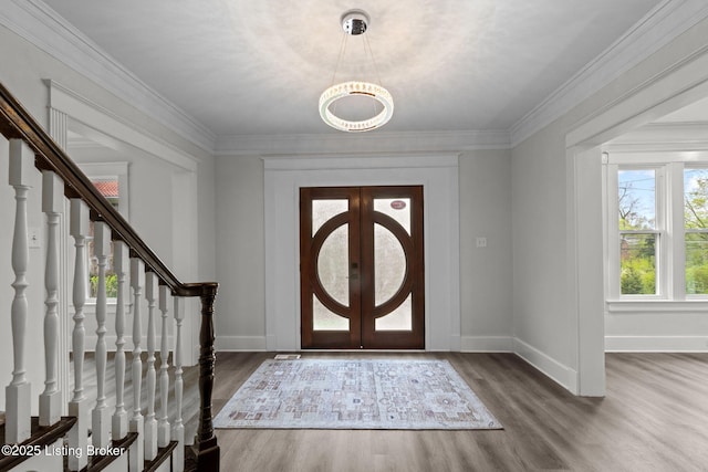 entrance foyer featuring stairway, baseboards, and wood finished floors