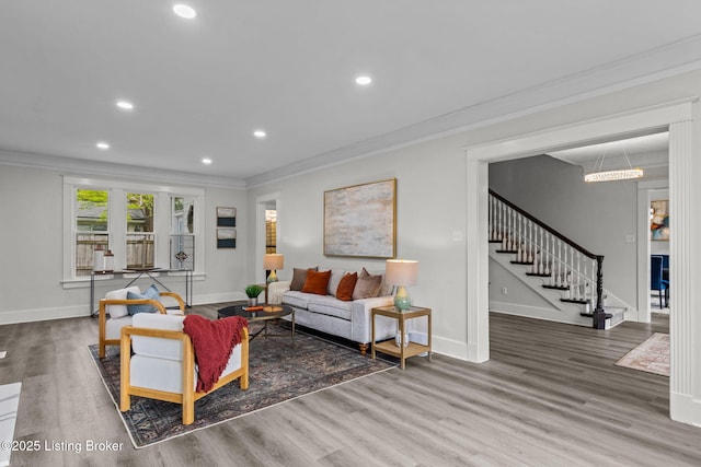 living room with baseboards, crown molding, recessed lighting, wood finished floors, and stairs