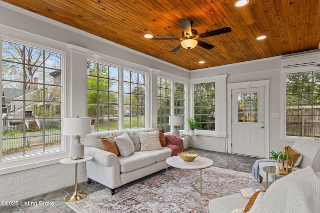 sunroom with an AC wall unit and plenty of natural light