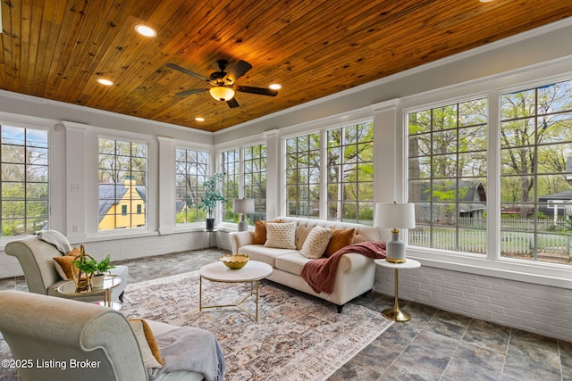 sunroom / solarium featuring stone finish flooring, recessed lighting, wooden ceiling, and ornamental molding