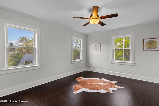 empty room featuring crown molding, visible vents, baseboards, and ceiling fan