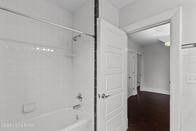 bathroom with  shower combination, baseboards, and wood finished floors