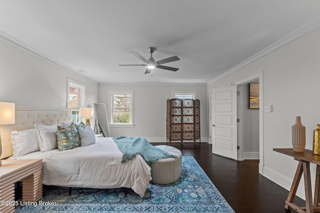 bedroom featuring crown molding, wood finished floors, baseboards, and a ceiling fan