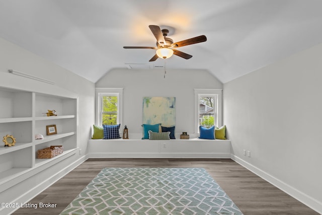 sitting room with a healthy amount of sunlight, ceiling fan, lofted ceiling, and built in features