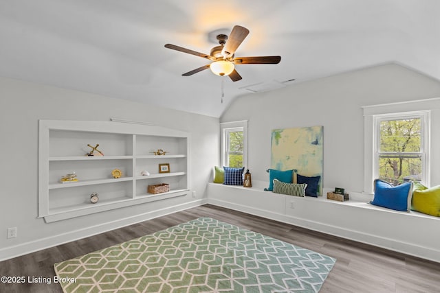 living area featuring wood finished floors, vaulted ceiling, and ceiling fan