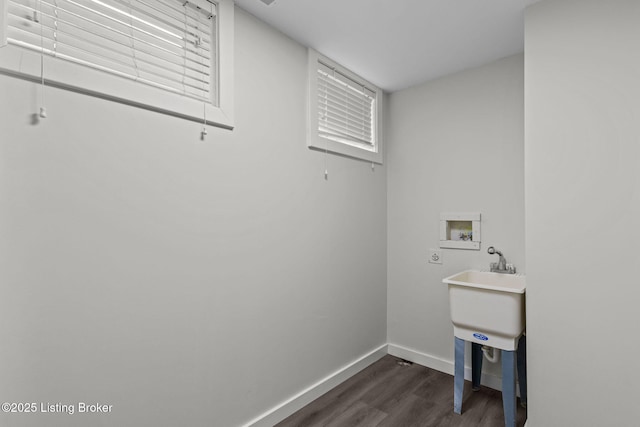 clothes washing area featuring baseboards, dark wood-style floors, laundry area, hookup for a washing machine, and a sink