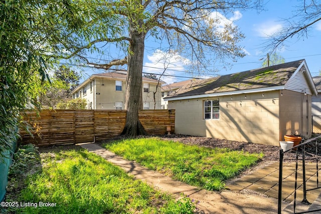 view of yard with fence and an outbuilding