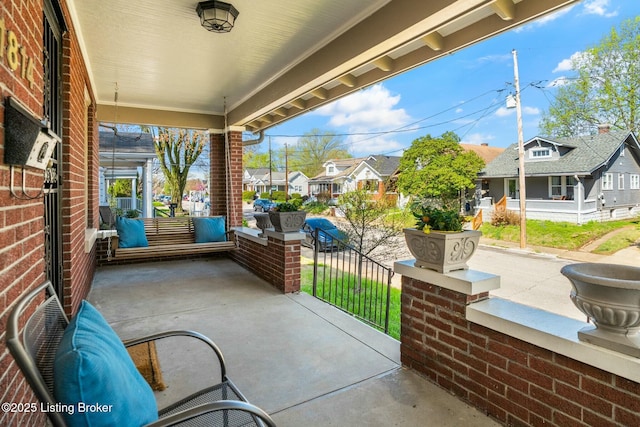 view of patio / terrace with a porch and a residential view