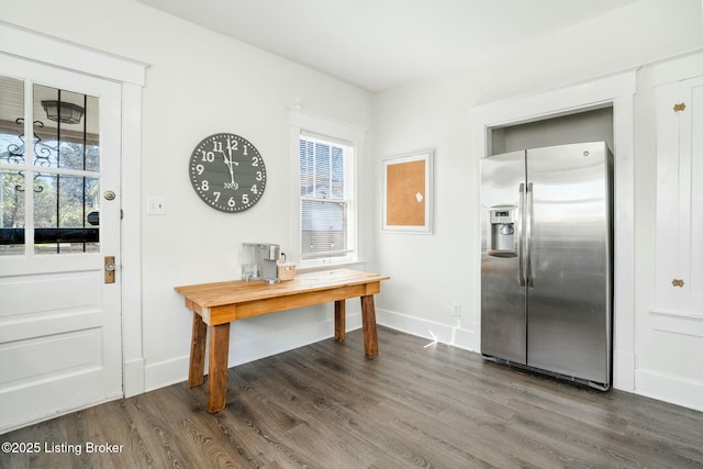 foyer featuring baseboards and dark wood finished floors