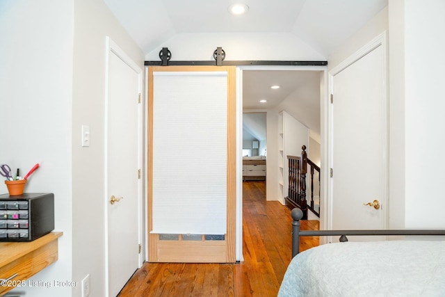 bedroom with recessed lighting, wood-type flooring, and lofted ceiling