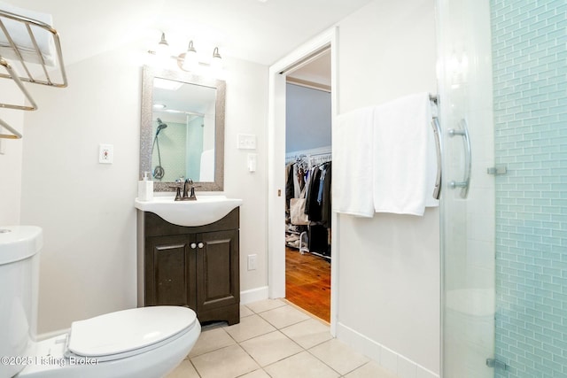 bathroom featuring toilet, a stall shower, and tile patterned flooring