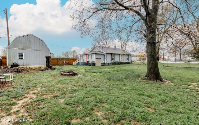 310 Wentworth Ave, Bedford, KY 40006 - view of yard featuring a barn, a fire pit, an outdoor structure, and fence