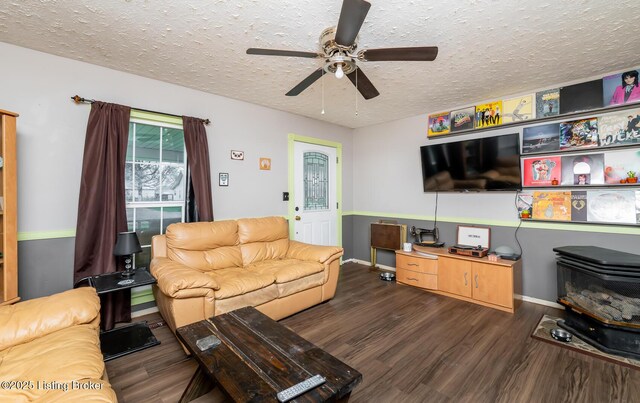 310 Wentworth Ave, Bedford, KY 40006 - living room featuring a textured ceiling, wood finished floors, a wood stove, and a ceiling fan