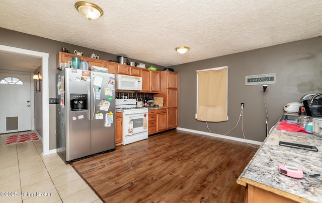310 Wentworth Ave, Bedford, KY 40006 - kitchen featuring a textured ceiling, light countertops, white appliances, and baseboards