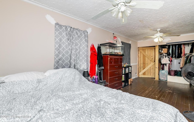 310 Wentworth Ave, Bedford, KY 40006 - bedroom with a closet, ornamental molding, a ceiling fan, a textured ceiling, and wood finished floors