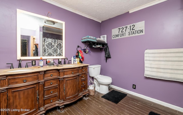 310 Wentworth Ave, Bedford, KY 40006 - bathroom with a sink, double vanity, wood finished floors, and a textured ceiling