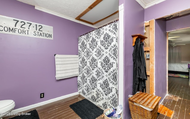 310 Wentworth Ave, Bedford, KY 40006 - full bath featuring baseboards, ornamental molding, a textured ceiling, toilet, and wood finished floors