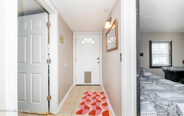 310 Wentworth Ave, Bedford, KY 40006 - entryway with a textured ceiling, light tile patterned flooring, and baseboards