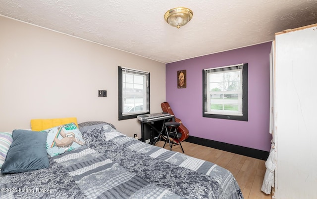 310 Wentworth Ave, Bedford, KY 40006 - bedroom with a textured ceiling, baseboards, and wood finished floors