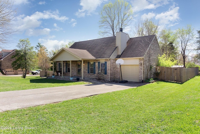ranch-style home with fence, a front lawn, brick siding, an attached garage, and concrete driveway