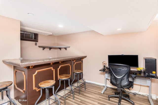 office featuring light wood-style flooring, baseboards, and recessed lighting