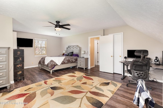 bedroom with dark wood-style flooring, ceiling fan, vaulted ceiling, and a textured ceiling
