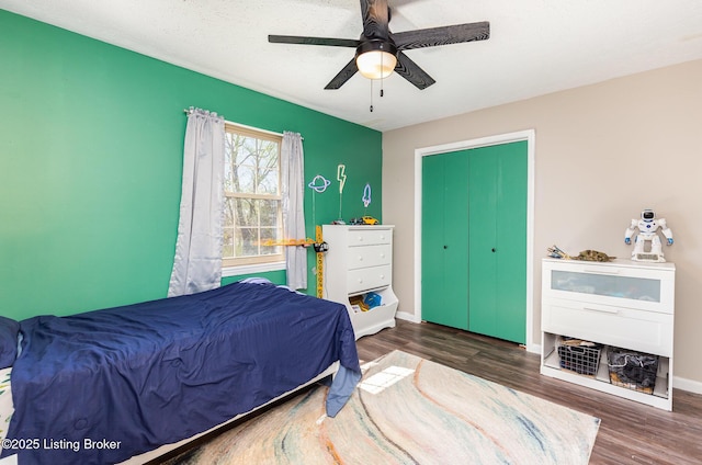 bedroom with baseboards, a ceiling fan, and wood finished floors
