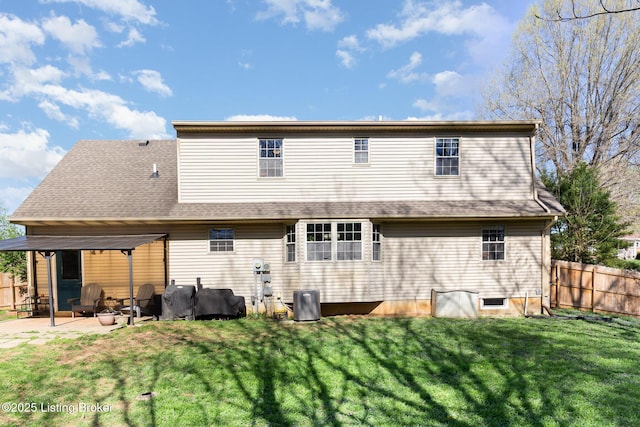 back of house featuring a patio area, central AC unit, a yard, fence, and a shingled roof