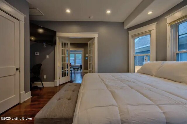 bedroom featuring wood finished floors, baseboards, and recessed lighting