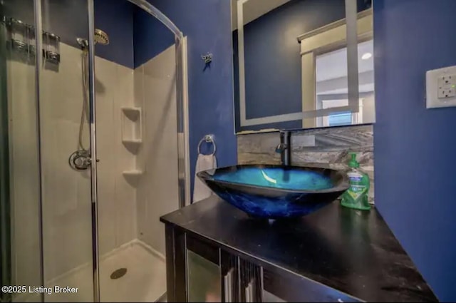 full bathroom with a shower stall and vanity
