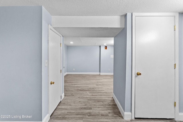 8006 Bramble Ln, Louisville, KY 40258 - corridor with a textured ceiling, wood finished floors, and baseboards
