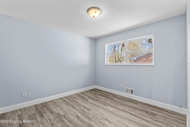 8006 Bramble Ln, Louisville, KY 40258 - spare room with visible vents, baseboards, wood finished floors, and a textured ceiling
