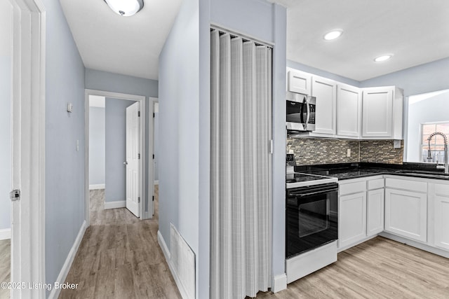 8006 Bramble Ln, Louisville, KY 40258 - kitchen with electric range, visible vents, stainless steel microwave, a sink, and dark countertops
