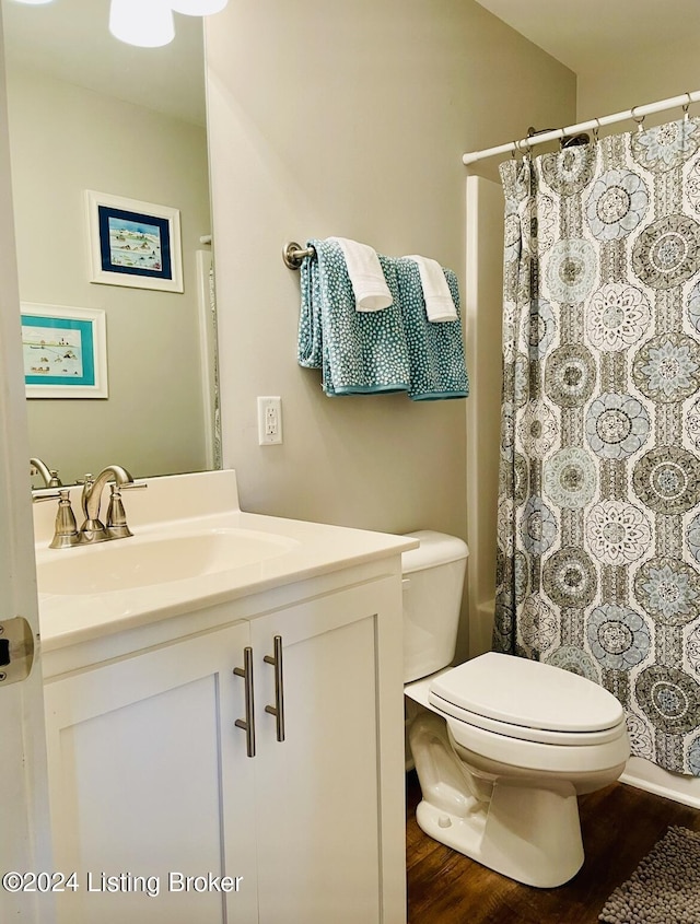 132 Cherry Ln, Leitchfield, KY 42754 - full bath with toilet, wood finished floors, vanity, and a shower with shower curtain