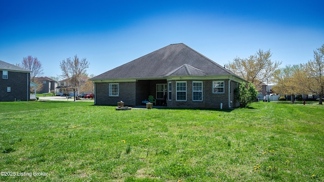 112 Tuscany Ln, Vine Grove, KY 40175 - back of house with a yard, brick siding, and roof with shingles