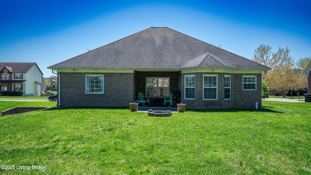 112 Tuscany Ln, Vine Grove, KY 40175 - back of house featuring a fire pit, a lawn, brick siding, and roof with shingles