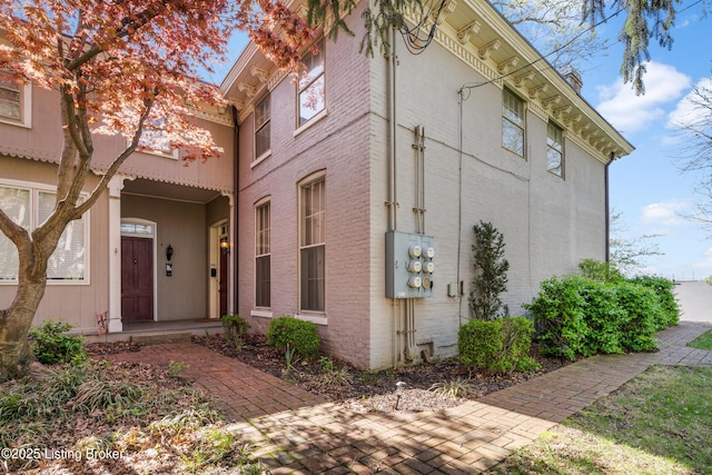 view of property exterior with brick siding
