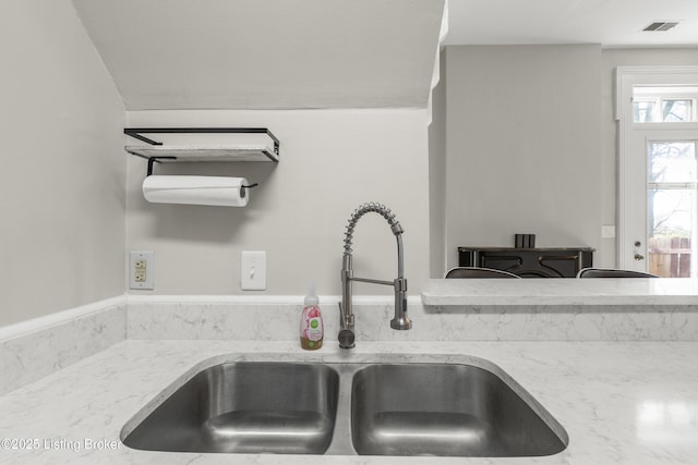kitchen with visible vents and a sink