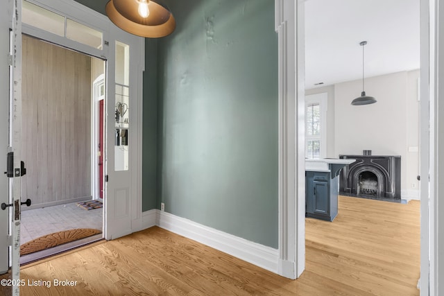 foyer entrance featuring baseboards and light wood-type flooring