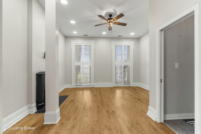 empty room featuring baseboards, a ceiling fan, recessed lighting, and light wood finished floors