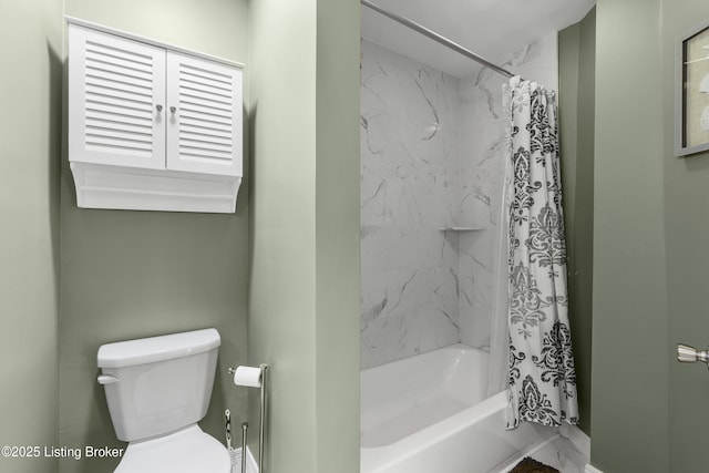 bathroom with shower / tub combo and toilet