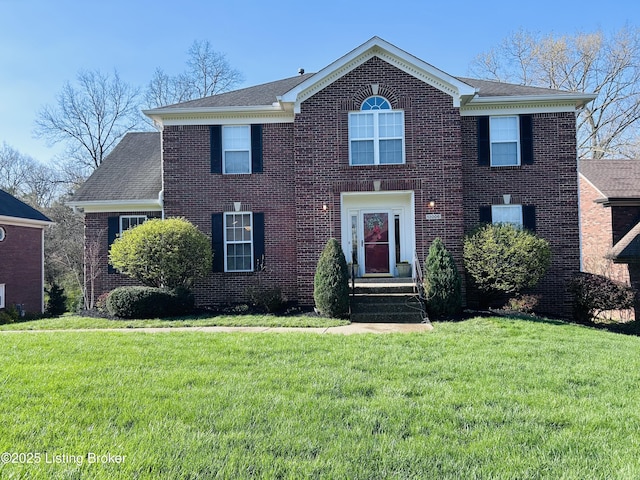 colonial-style house with a front yard and brick siding